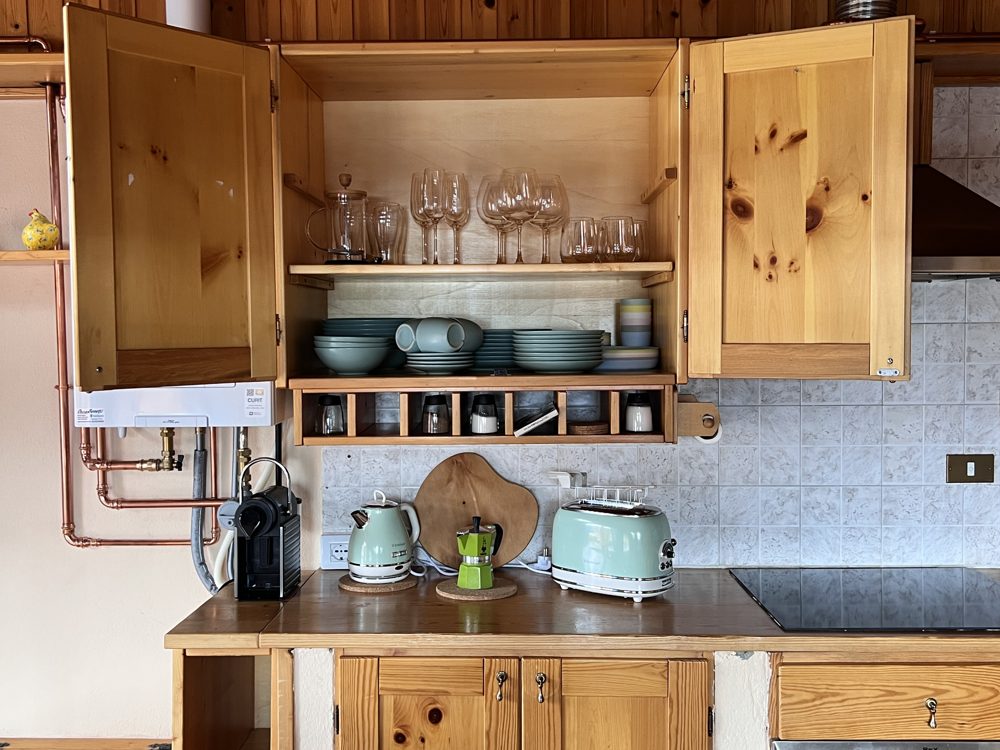 Kitchen close-up: pastel kettle, Bialetti moka, coffee machine and toaster