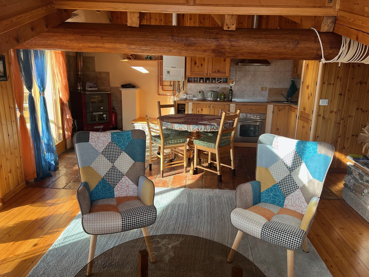 Open kitchen and dining table under the wooden beams