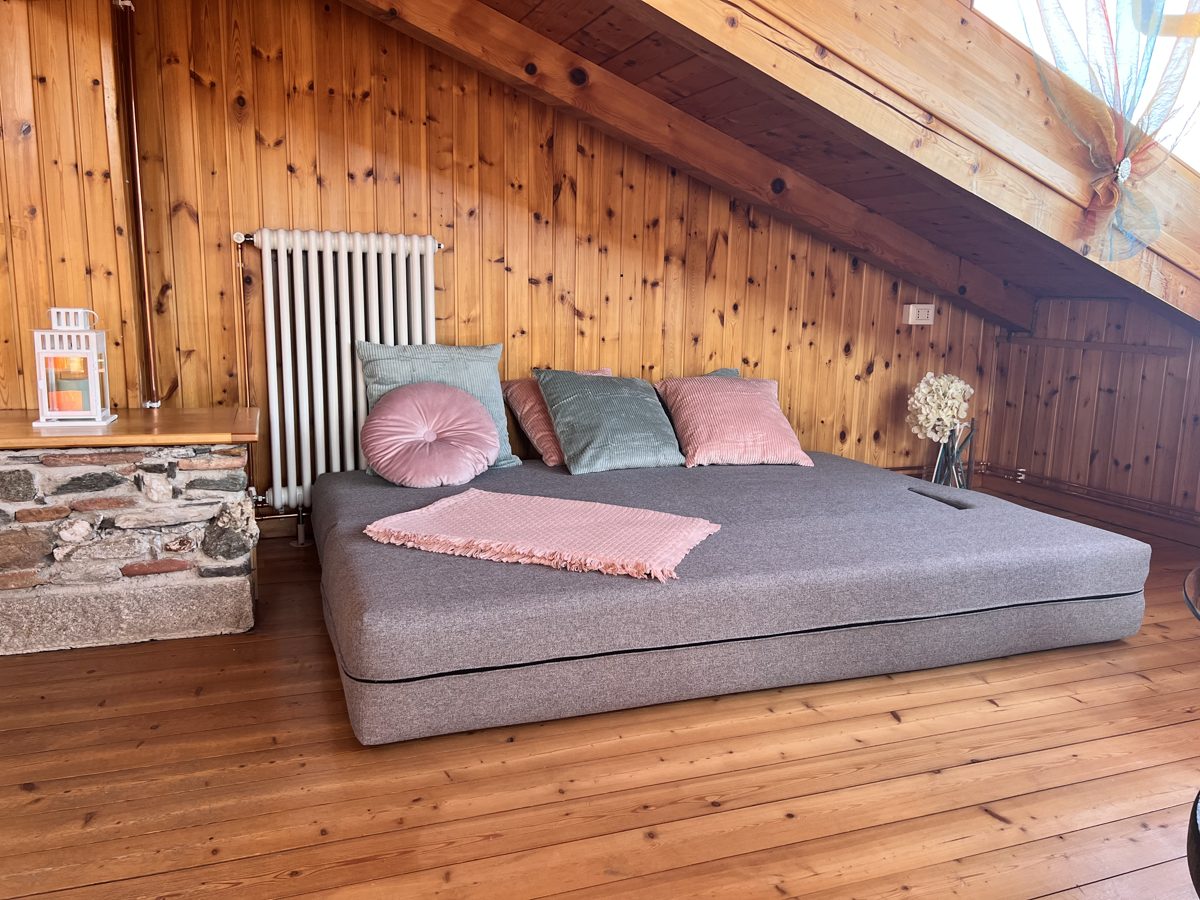 The sofa unfolded into a full flat double bed under the sloping wooden ceiling